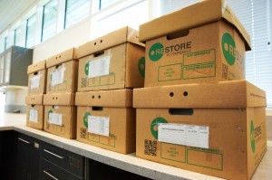 Eight cardboard boxes sat on a shelf